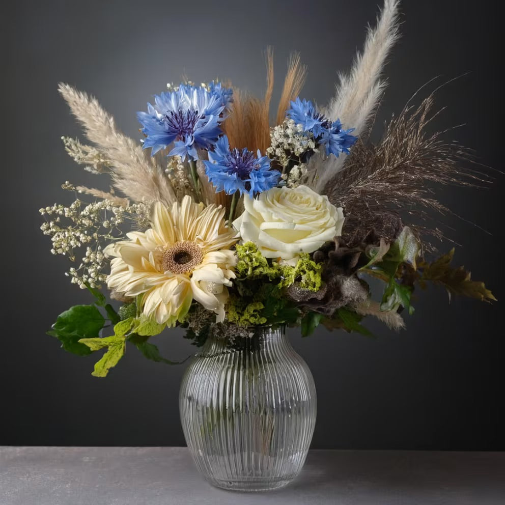A winter-inspired floral arrangement with elegant white blooms.